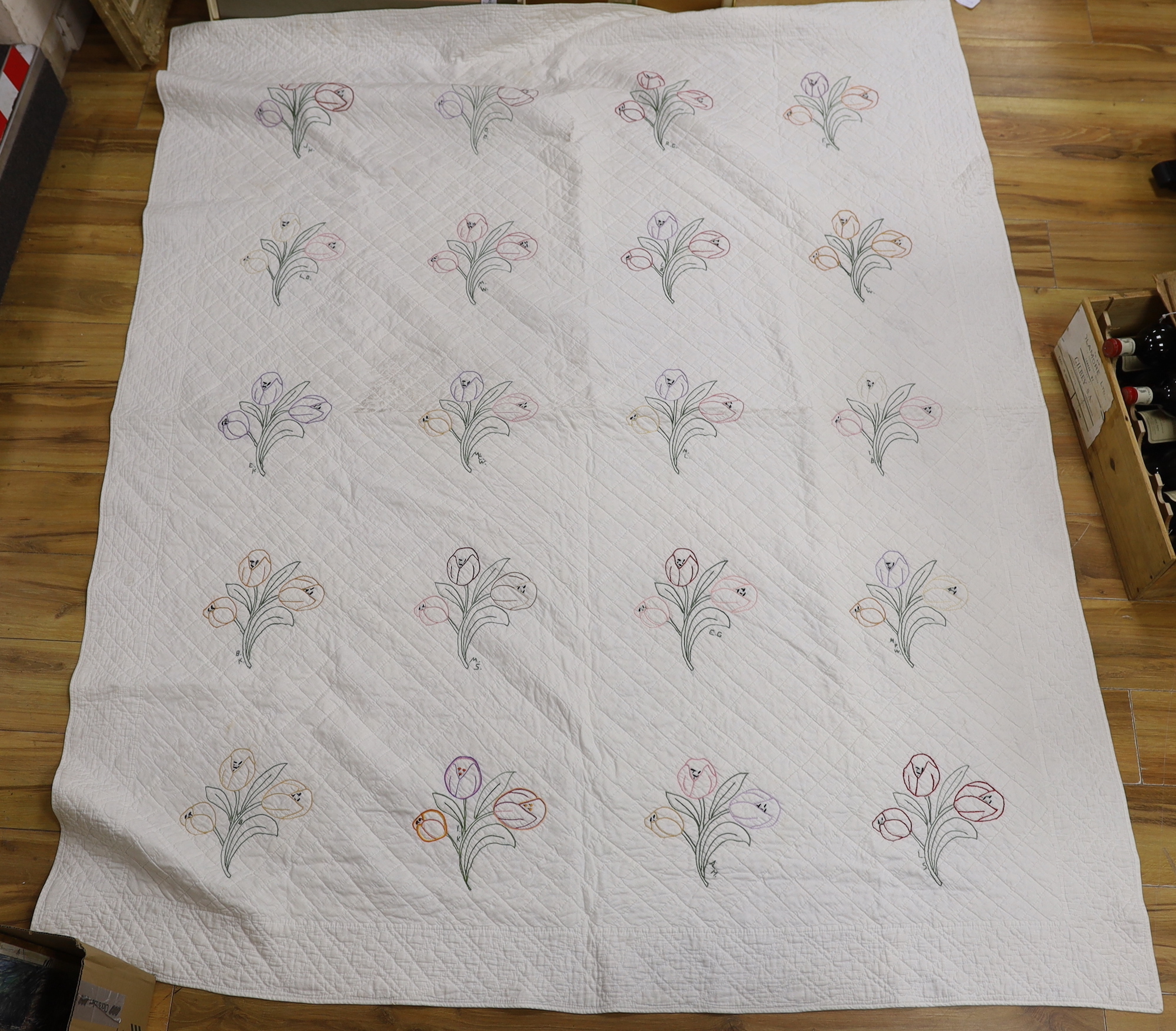 A 1920's American friendship dowry quilt embroidered with flowers, initialled